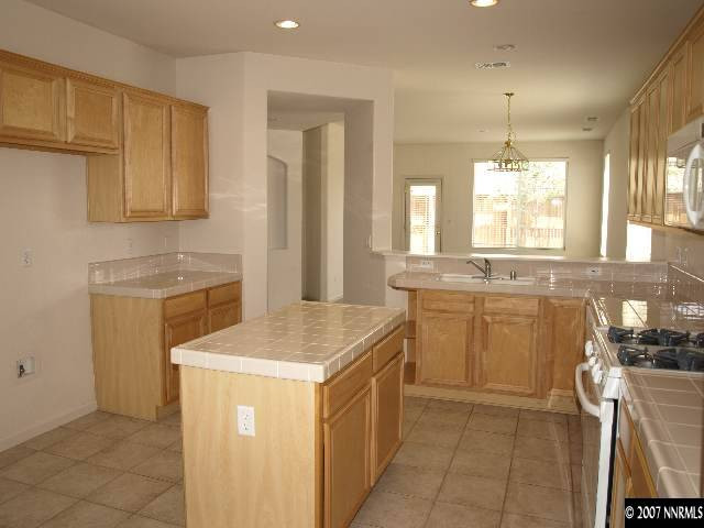 10532 Iron Point Circle Reno, NV 89521 - Photo 3 of 6 a kitchen with a sink stove and cabinets