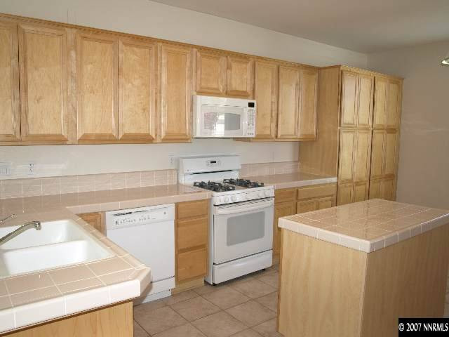 10532 Iron Point Circle Reno, NV 89521 - Photo 4 of 6 a kitchen with a sink cabinets and appliances