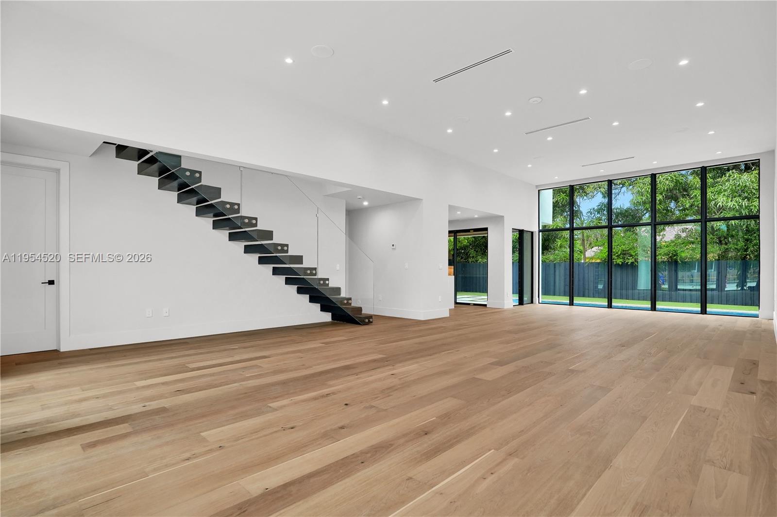 229 Northwest 42nd Street Miami, FL 33127 - Photo 12 of 37 a view of an empty room with wooden floor and stairs