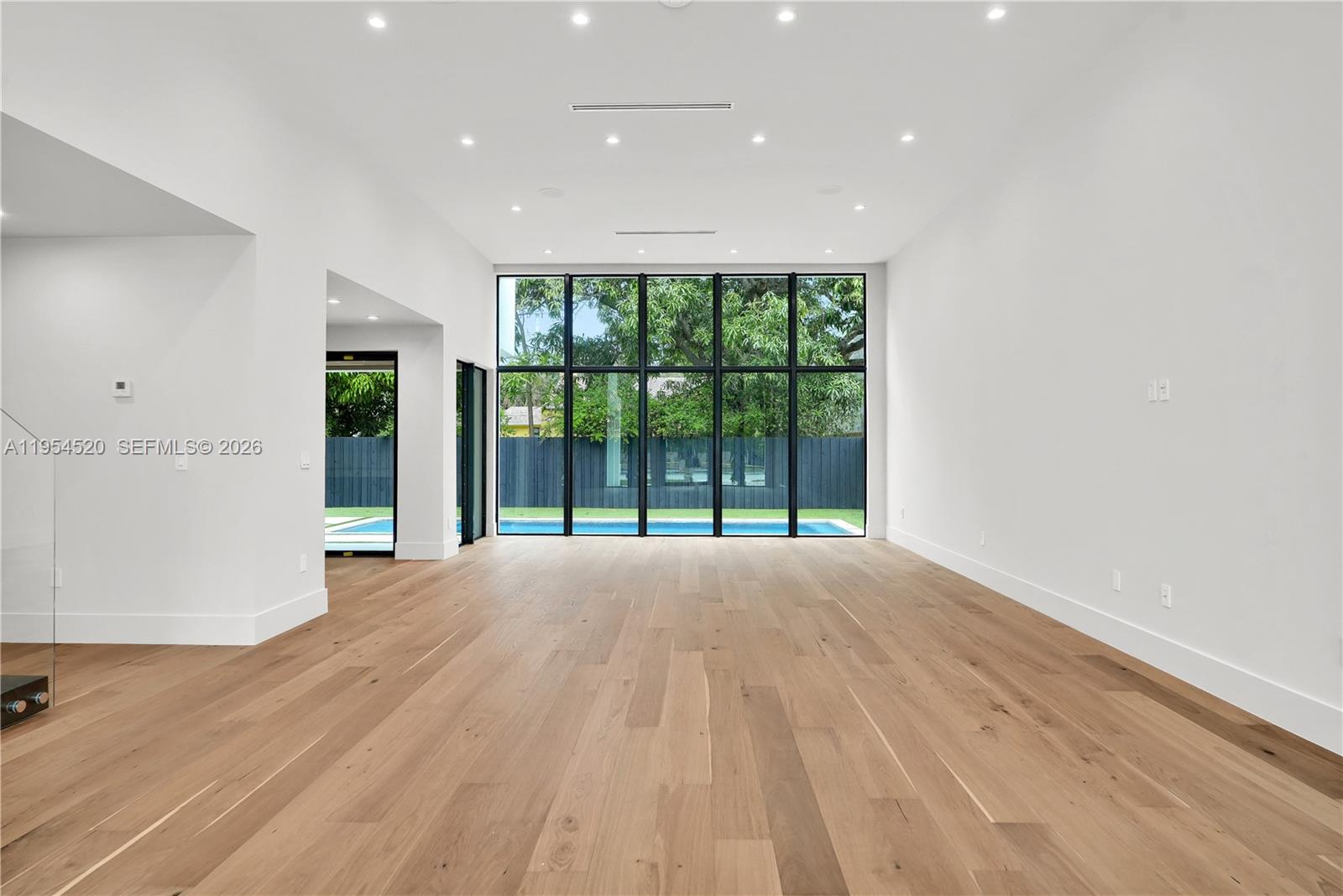 229 Northwest 42nd Street Miami, FL 33127 - Photo 14 of 37 a view of an empty room with wooden floor and a window