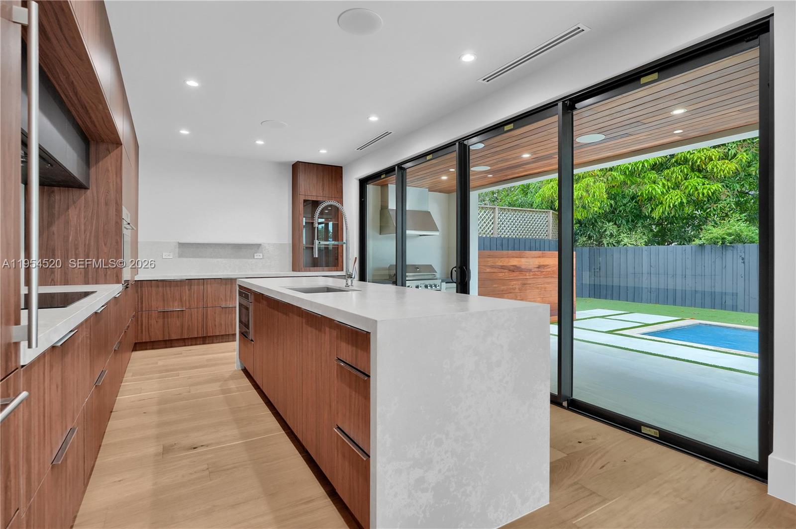 229 Northwest 42nd Street Miami, FL 33127 - Photo 15 of 37 a large kitchen with kitchen island a large window