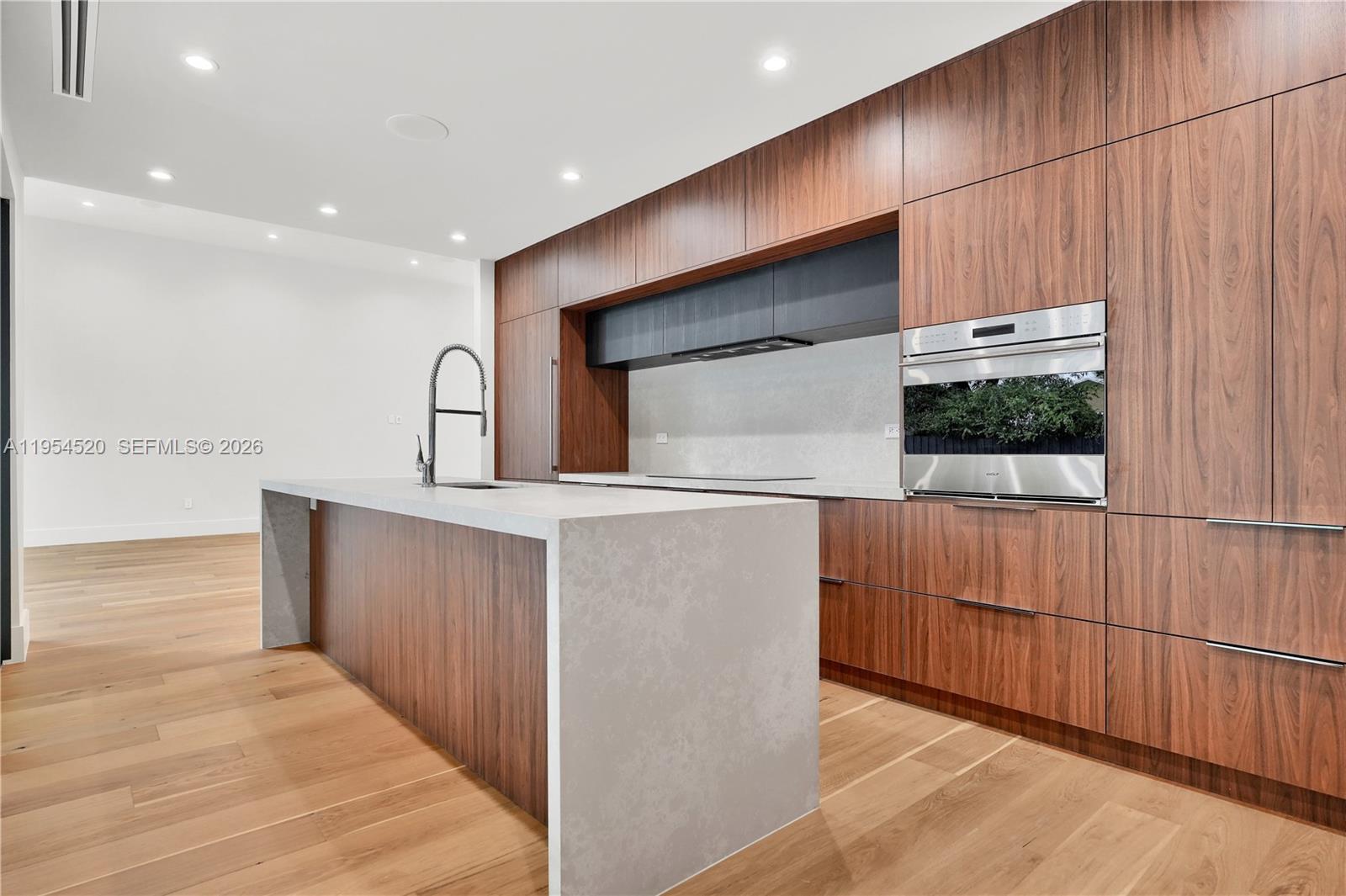 229 Northwest 42nd Street Miami, FL 33127 - Photo 17 of 37 a view of kitchen with stainless steel appliances wooden floor and chair