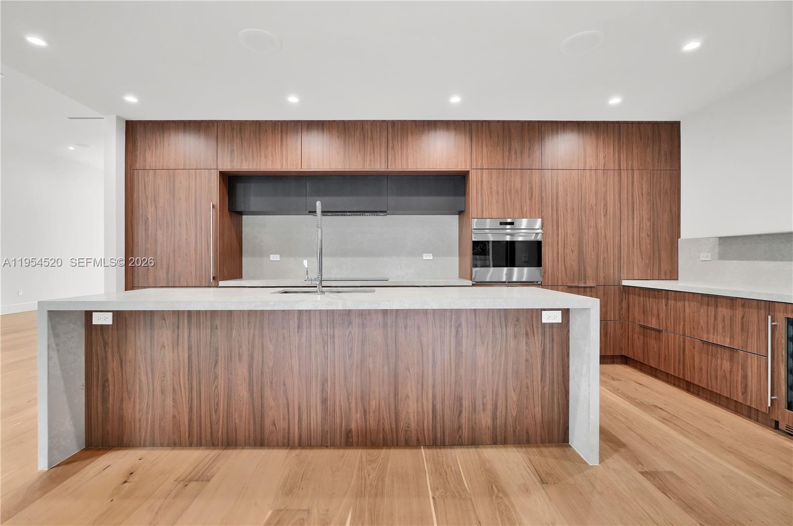 229 Northwest 42nd Street Miami, FL 33127 - Photo 18 of 37 a kitchen with a sink and wooden cabinets