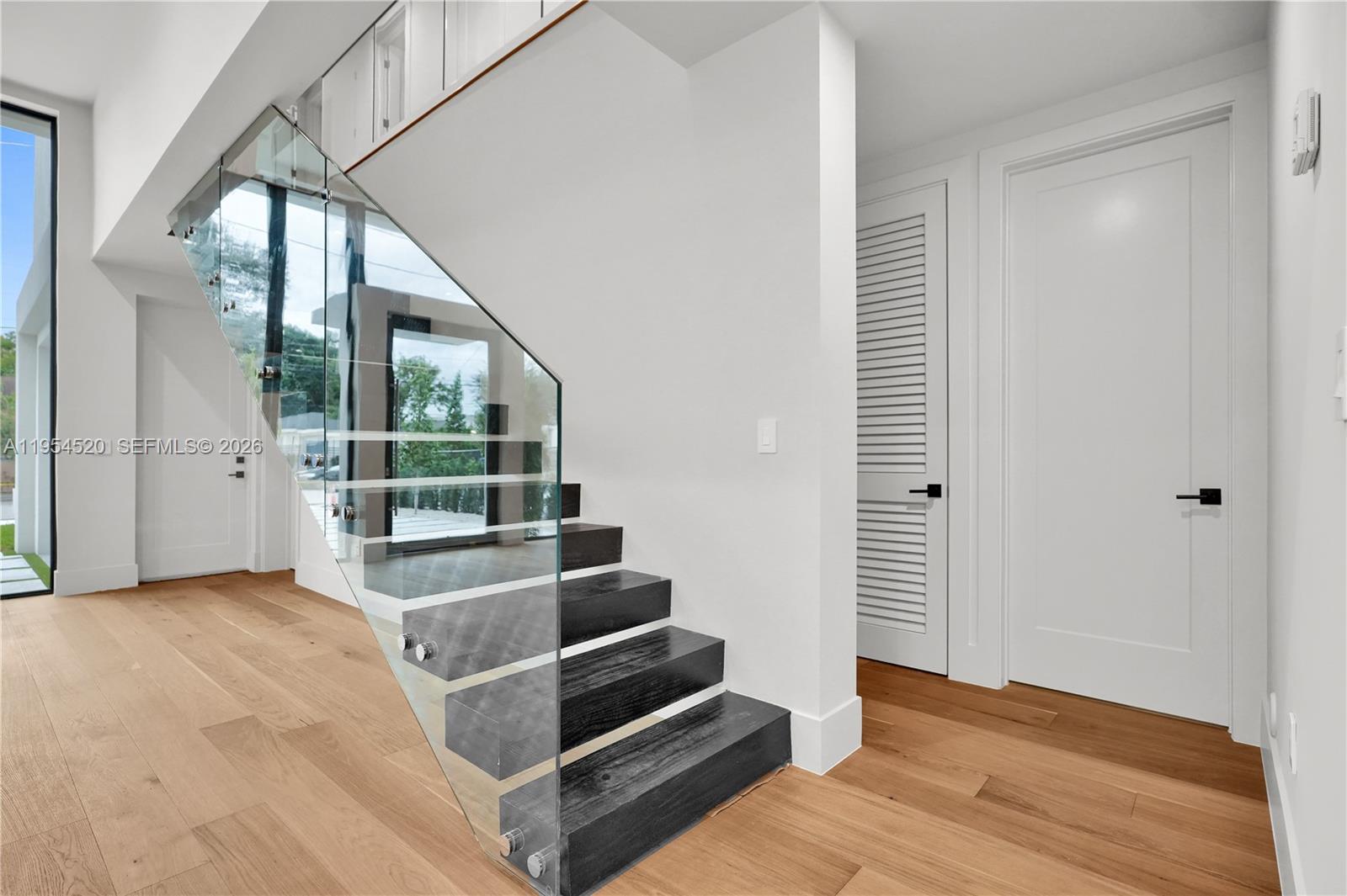 229 Northwest 42nd Street Miami, FL 33127 - Photo 19 of 37 a view of wooden floor and windows in a room