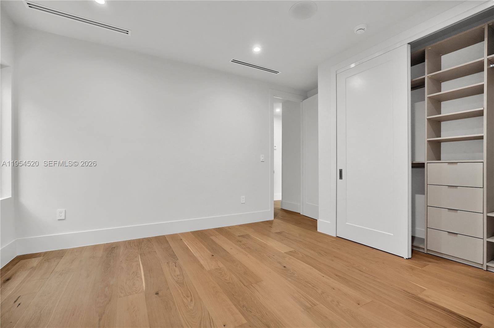 229 Northwest 42nd Street Miami, FL 33127 - Photo 21 of 37 a view of an empty room with wooden floor
