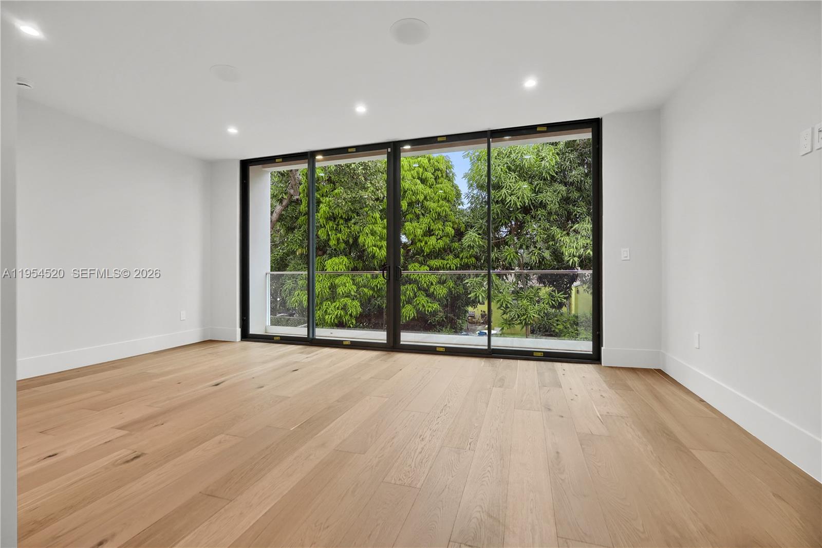229 Northwest 42nd Street Miami, FL 33127 - Photo 22 of 37 a view of an empty room with wooden floor and a window
