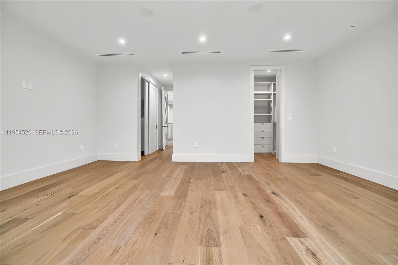 229 Northwest 42nd Street Miami, FL 33127 - Photo 23 of 37 an empty room with wooden floor and windows