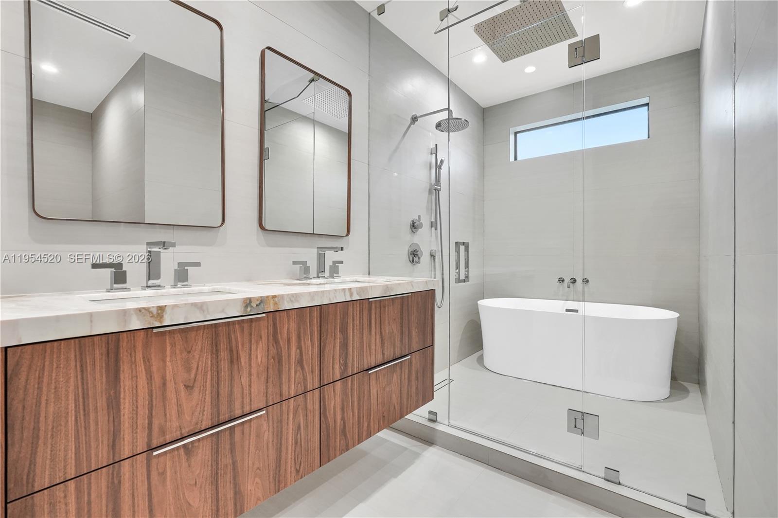 229 Northwest 42nd Street Miami, FL 33127 - Photo 24 of 37 a bathroom with a double vanity sink mirror and double
