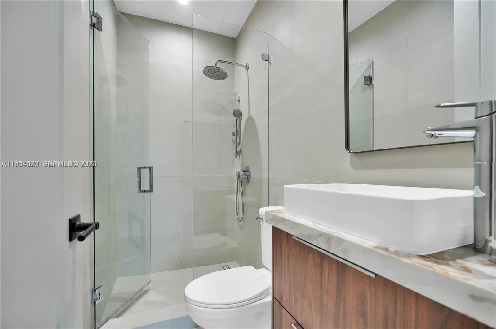 229 Northwest 42nd Street Miami, FL 33127 - Photo 26 of 37 a bathroom with a sink a toilet and shower