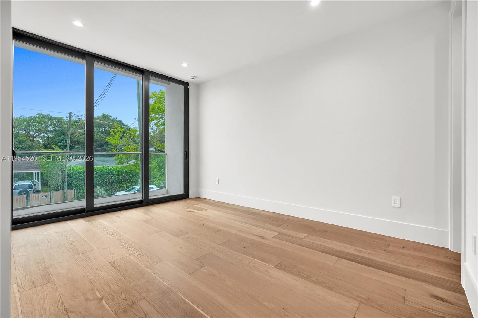 229 Northwest 42nd Street Miami, FL 33127 - Photo 29 of 37 a view of a big room with wooden floor and windows