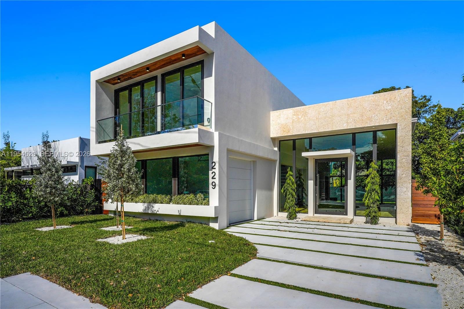 229 Northwest 42nd Street Miami, FL 33127 - Photo 4 of 37 a view of a house with a large window and a yard with plants