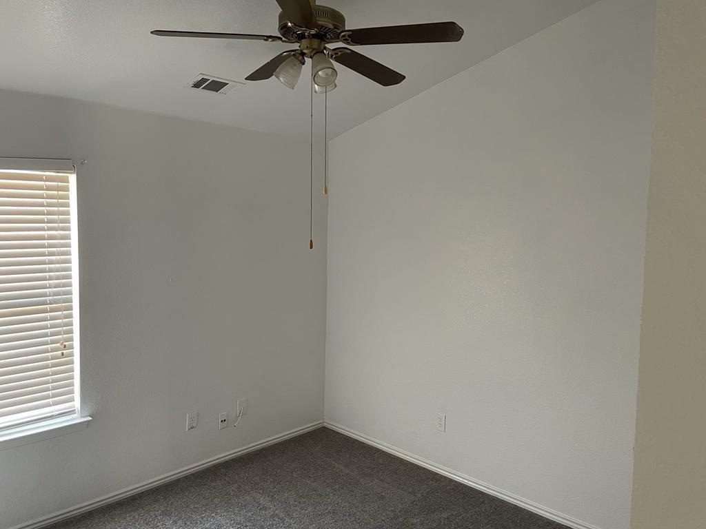 6324 Geneva Lane Fort Worth, TX 76131 - Photo 12 of 18 an empty room with a window and a fan
