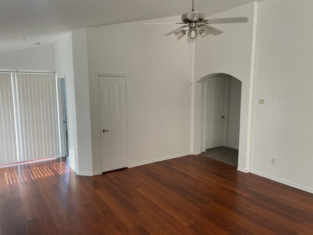 6324 Geneva Lane Fort Worth, TX 76131 - Photo 2 of 18 an empty room with wooden floor ceiling fan and windows