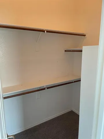 a bathroom with a granite countertop sink and a toilet