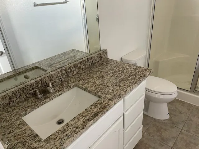 a bathroom with a shower and a toilet