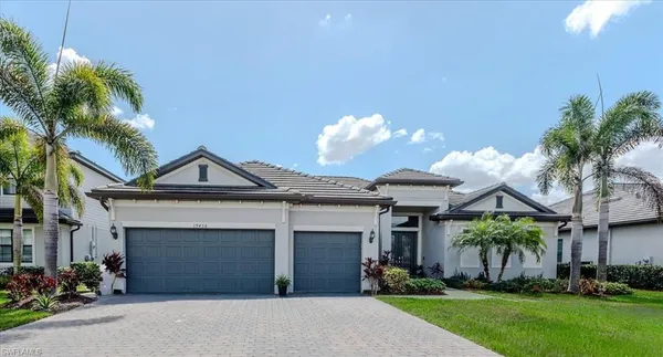 a front view of a house with a yard and garage