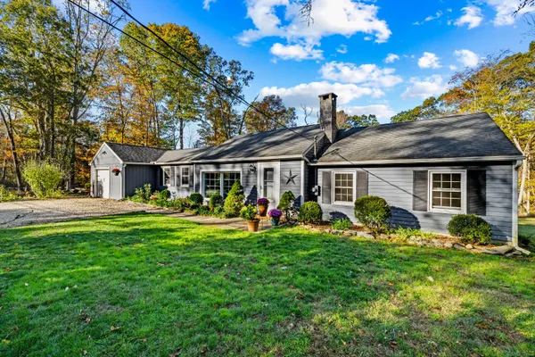 a front view of house with yard outdoor seating and green space