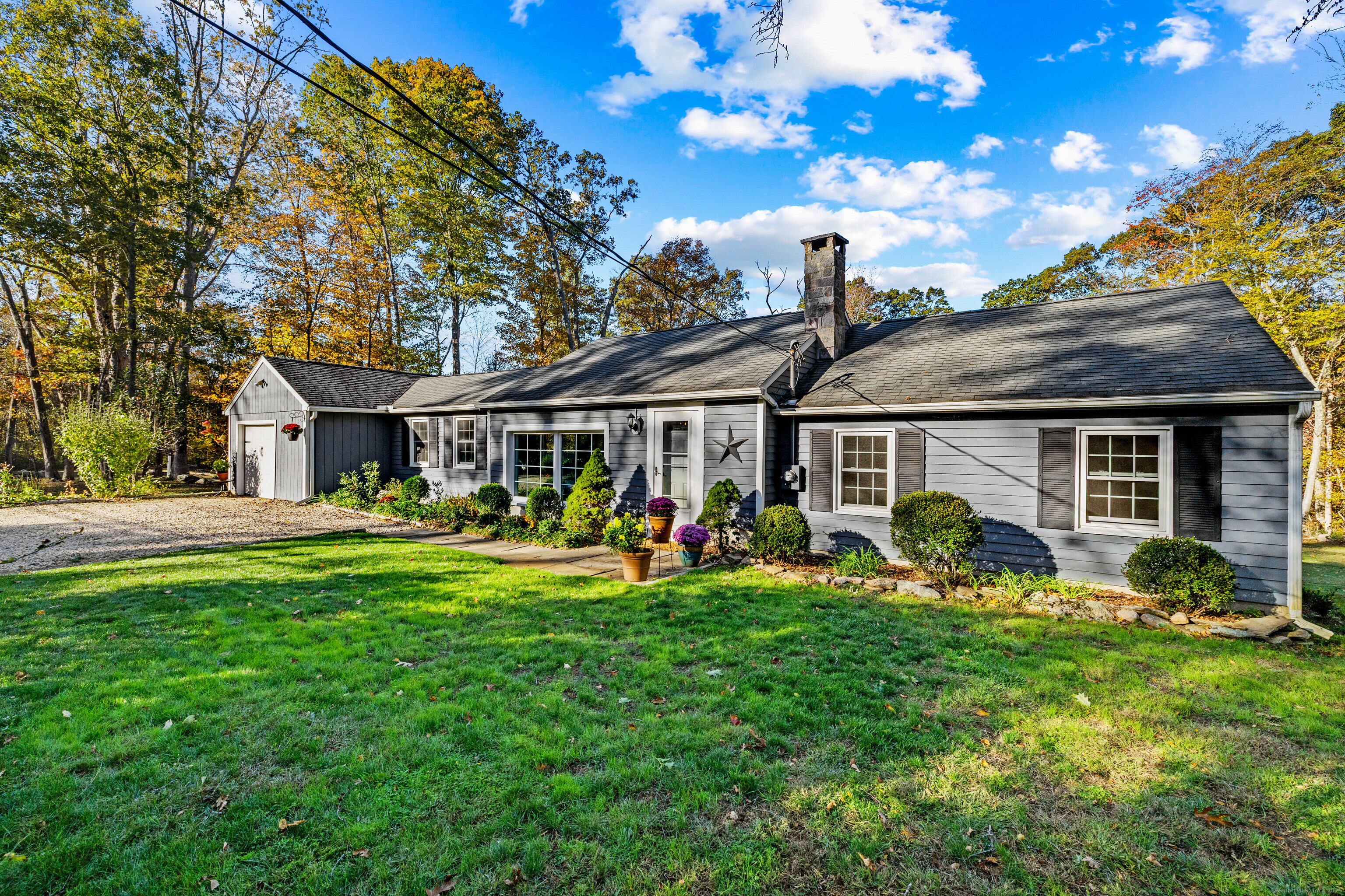 a front view of house with yard outdoor seating and green space