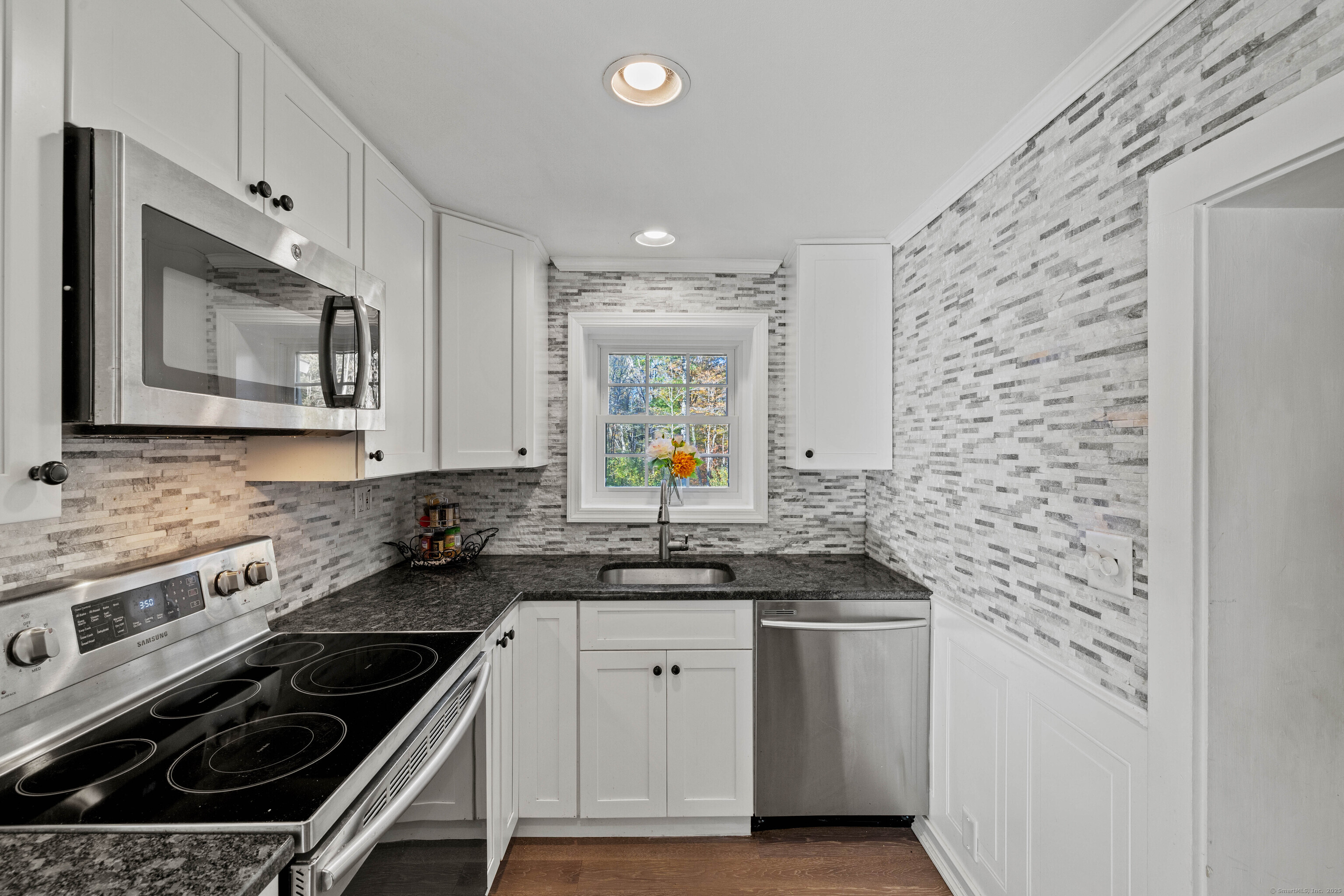 779 Summer Hill Road Madison, CT 06443 - Photo 11 of 40 a kitchen with a sink stove and microwave