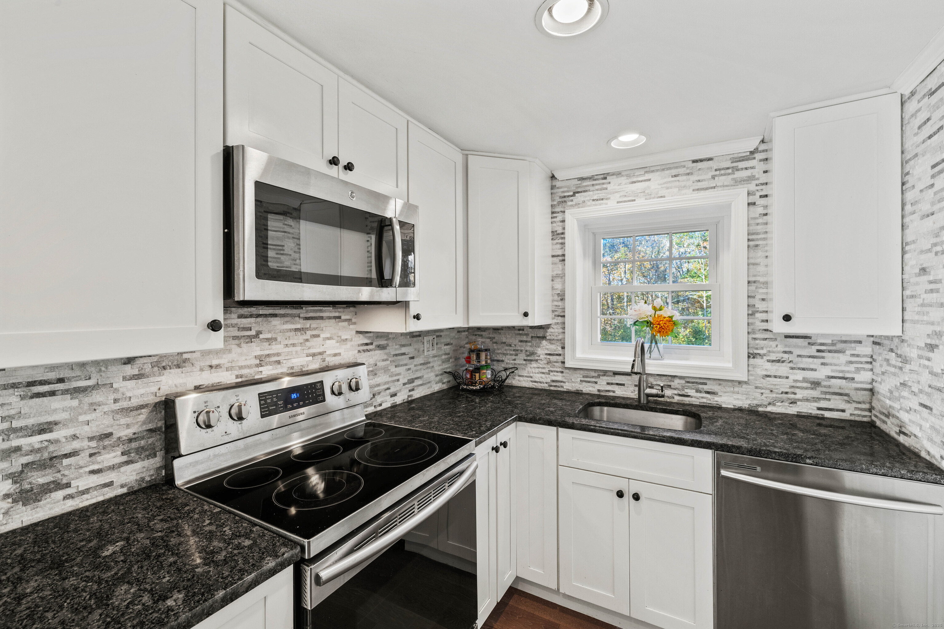779 Summer Hill Road Madison, CT 06443 - Photo 12 of 40 a kitchen with stainless steel appliances granite countertop a sink stove and microwave