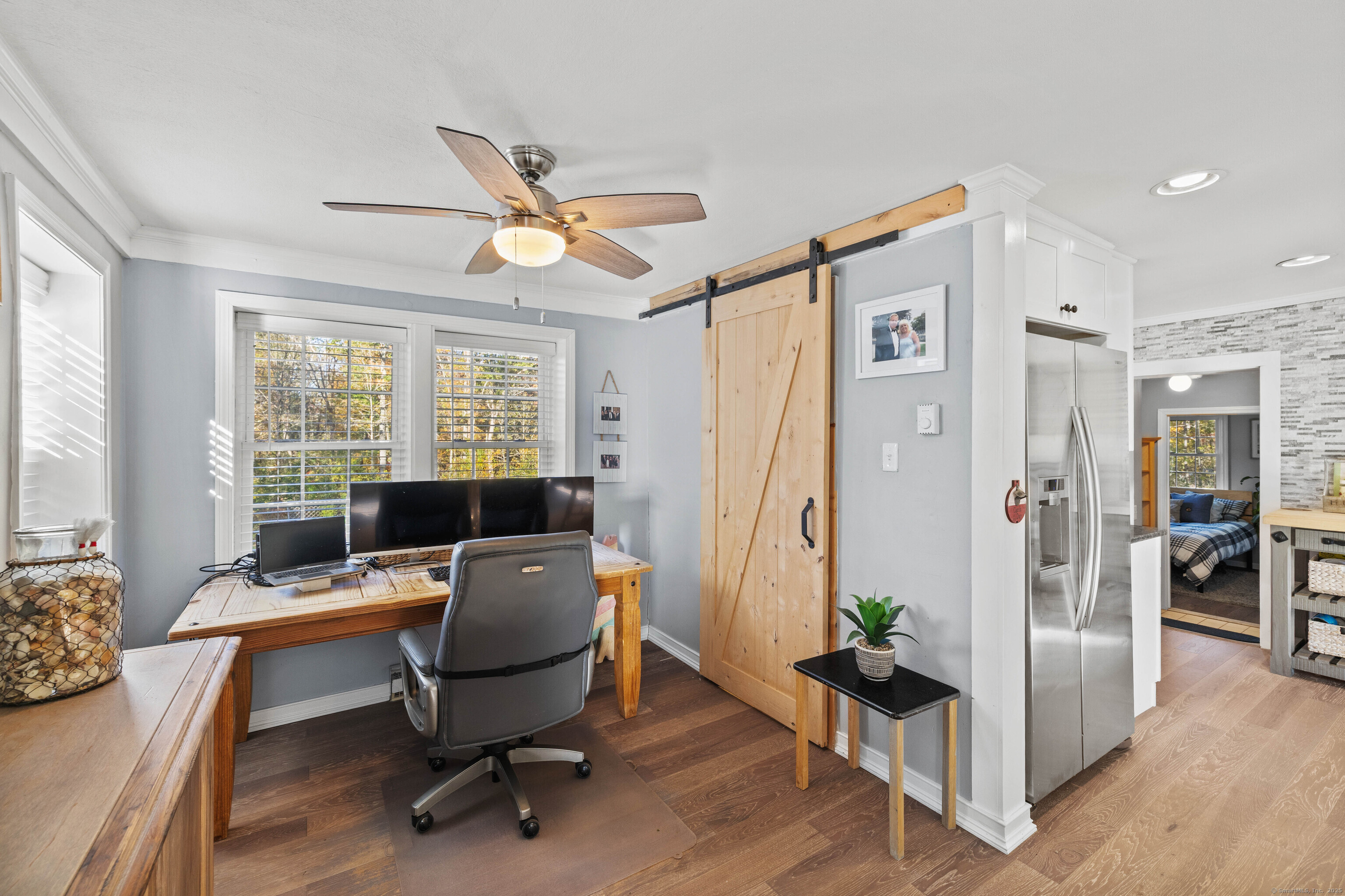 779 Summer Hill Road Madison, CT 06443 - Photo 15 of 40 a view of a workspace with furniture and a window