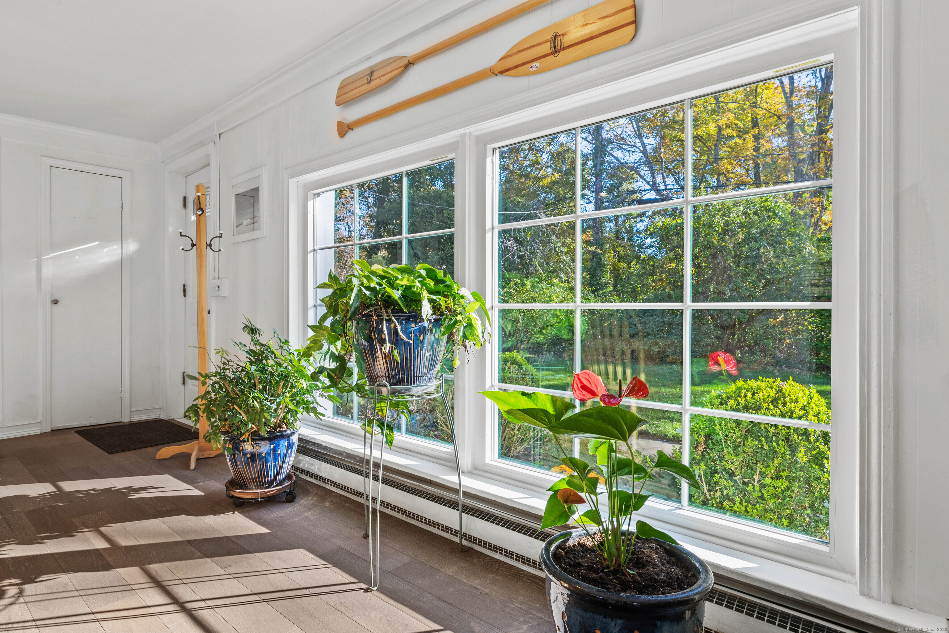 779 Summer Hill Road Madison, CT 06443 - Photo 20 of 40 a flower pot with a bench in front of a window