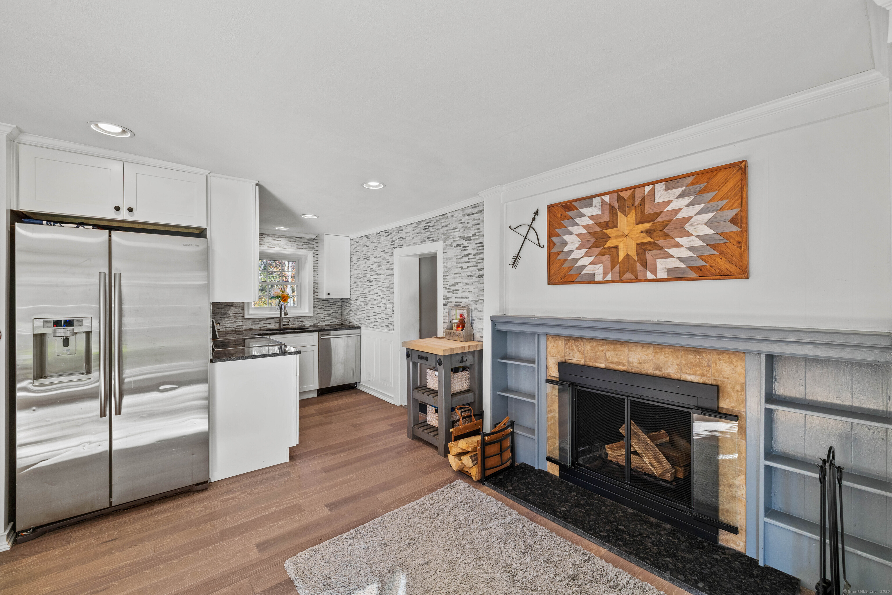 779 Summer Hill Road Madison, CT 06443 - Photo 22 of 40 a kitchen with a refrigerator and a fireplace