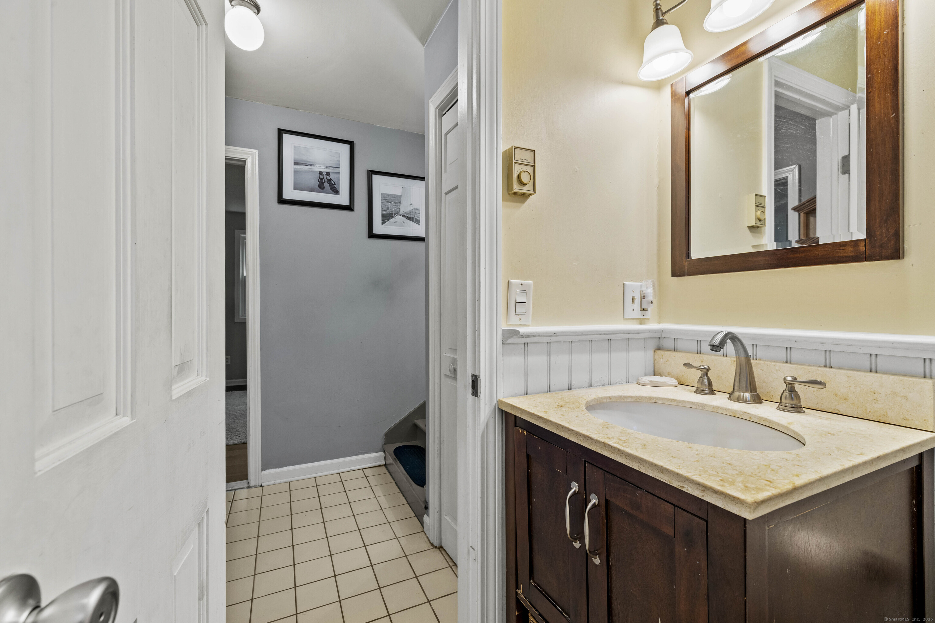 779 Summer Hill Road Madison, CT 06443 - Photo 24 of 40 a bathroom with a sink and a mirror