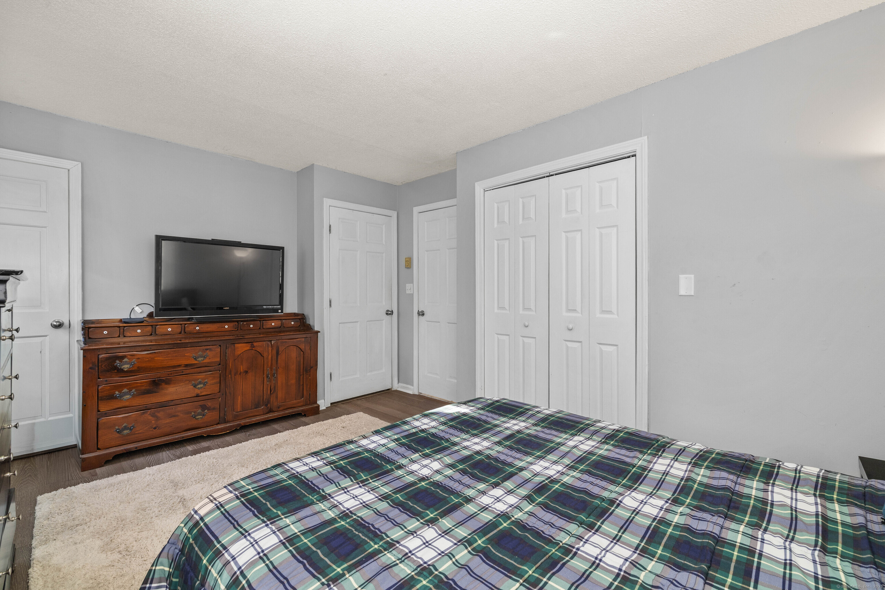 779 Summer Hill Road Madison, CT 06443 - Photo 29 of 40 a bedroom with a bed and flat screen tv