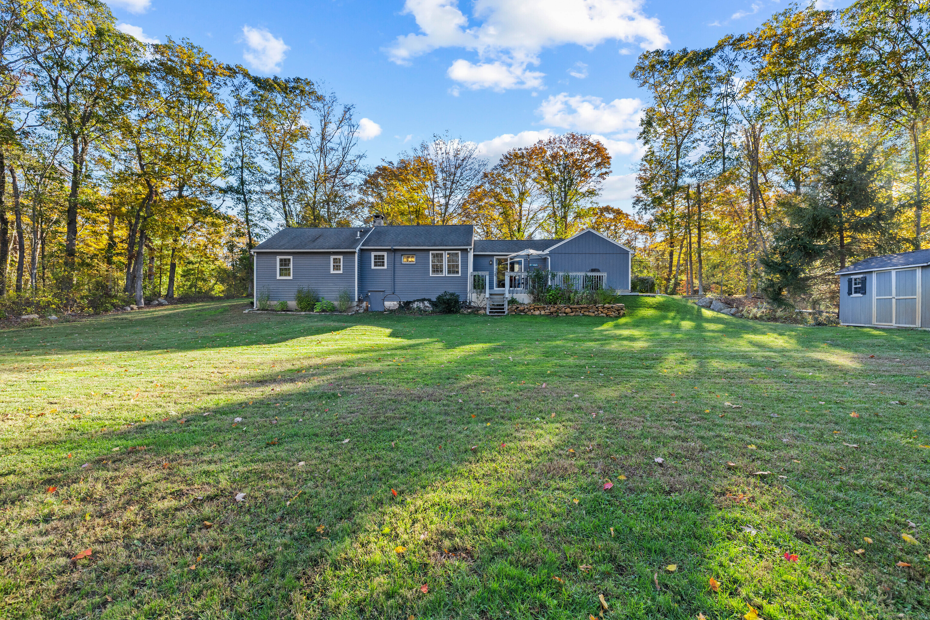 779 Summer Hill Road Madison, CT 06443 - Photo 33 of 40 a view of a big house with a big yard and large trees