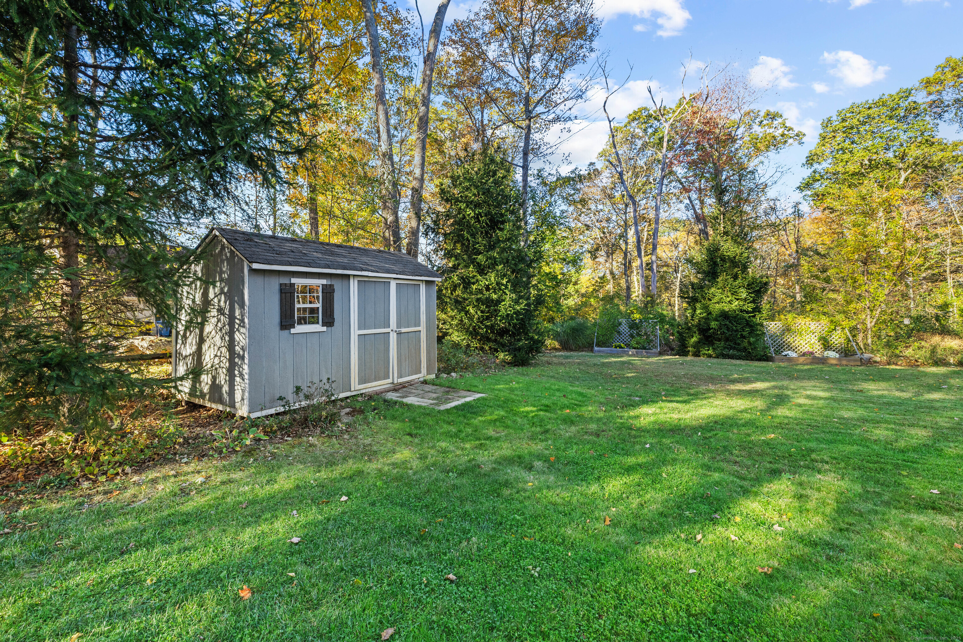 779 Summer Hill Road Madison, CT 06443 - Photo 36 of 40 a view of a house with backyard and garden
