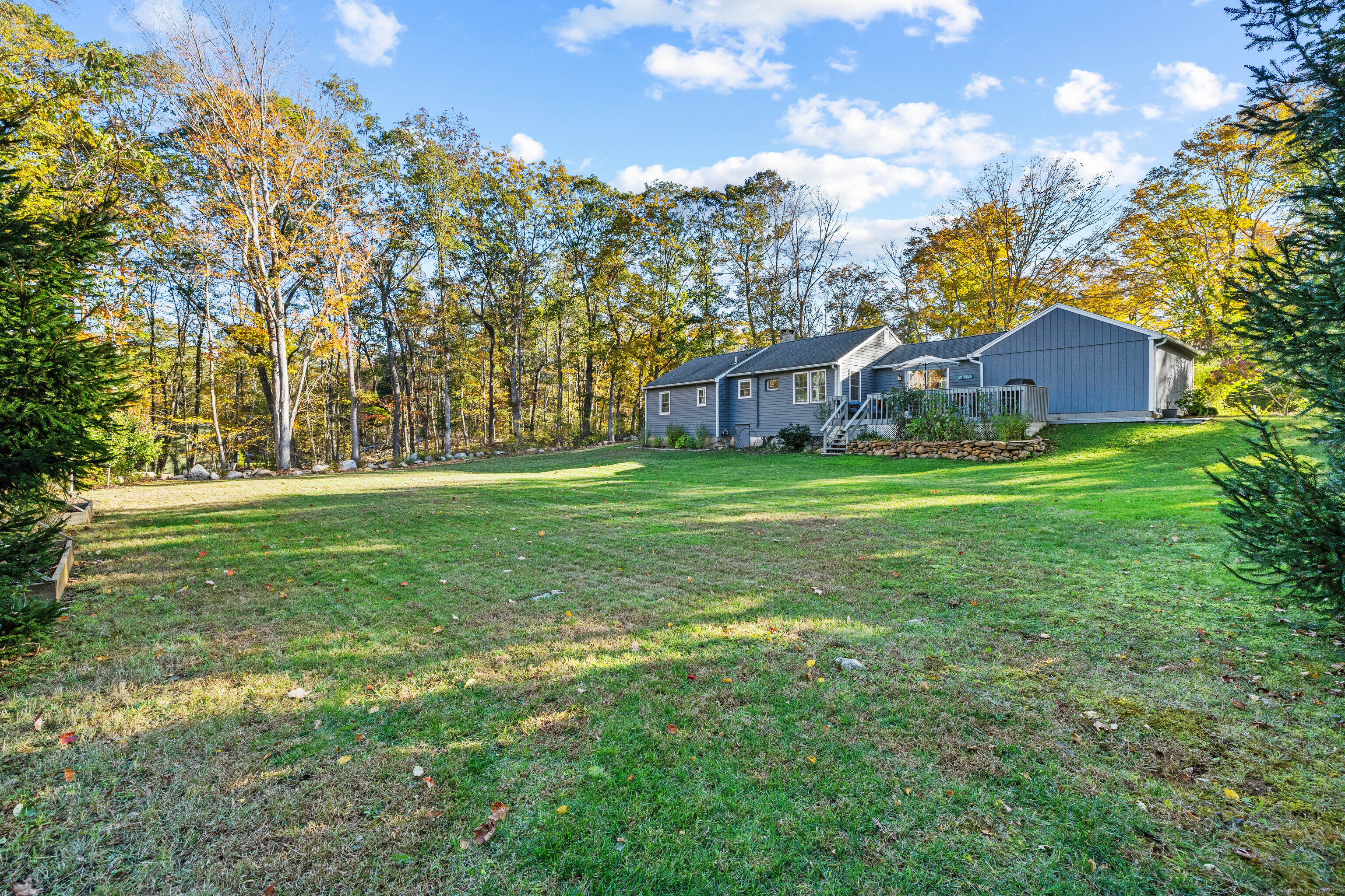 779 Summer Hill Road Madison, CT 06443 - Photo 38 of 40 a view of a house with a big yard and large trees