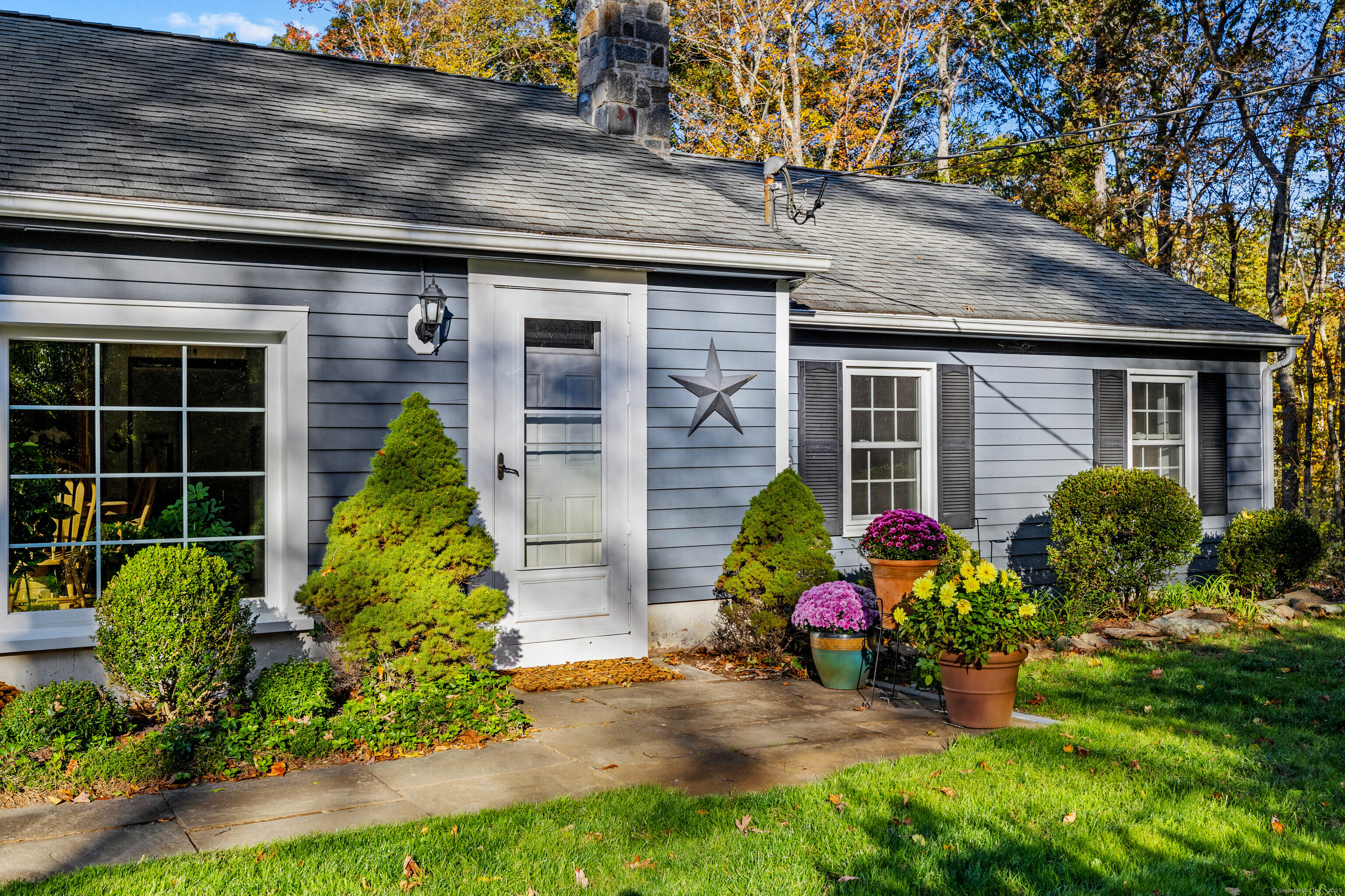 779 Summer Hill Road Madison, CT 06443 - Photo 39 of 40 a front view of a house with yard and outdoor seating