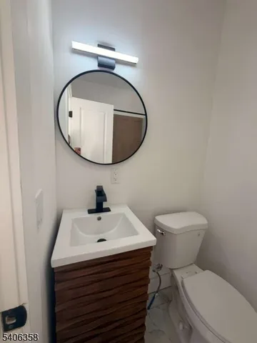 a bathroom with a sink a mirror and toilet
