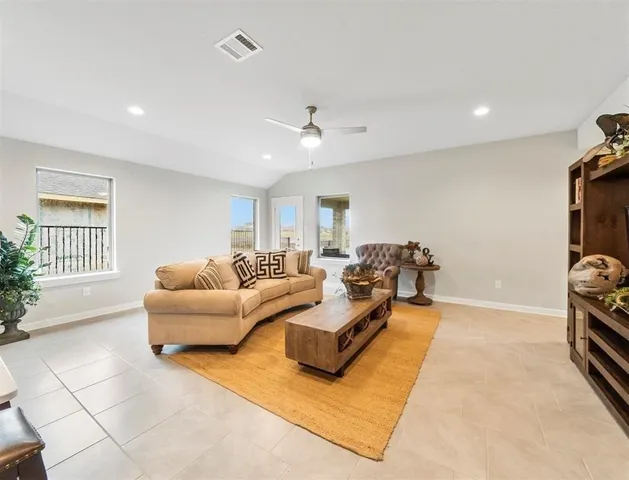 a living room with furniture rug and window