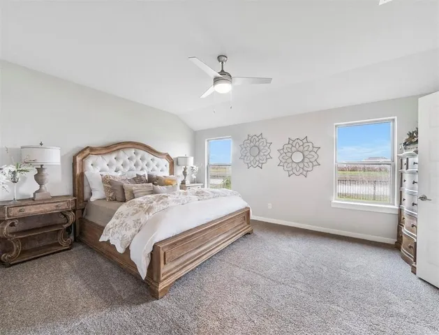 a spacious bedroom with a bed and a window