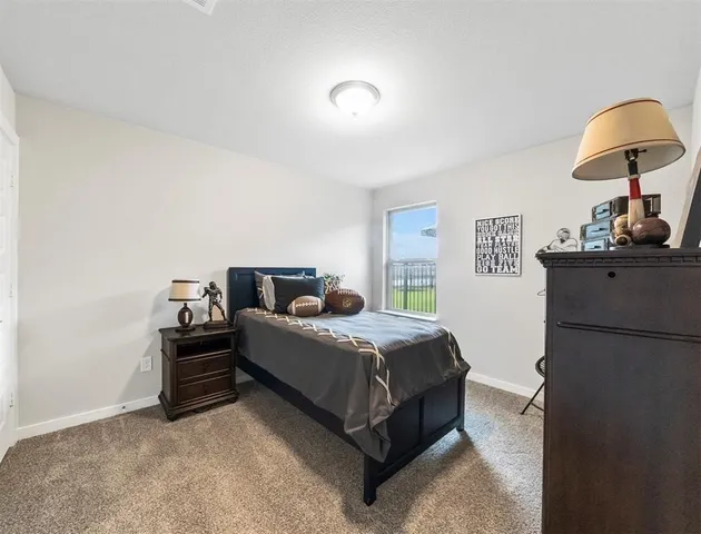 a bedroom with bed cabinet and mirror