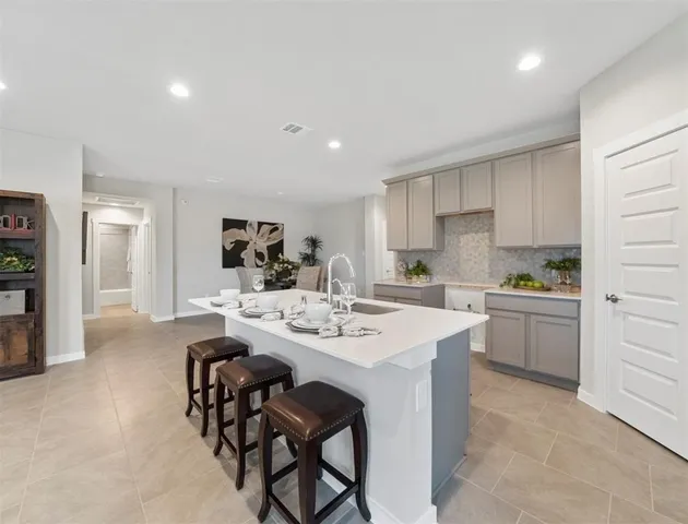 a kitchen with stainless steel appliances kitchen island granite countertop a sink and cabinets
