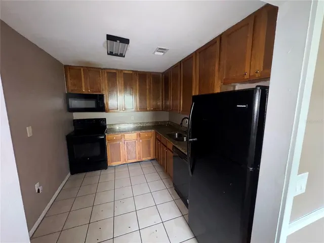 a kitchen with a refrigerator stove and cabinets