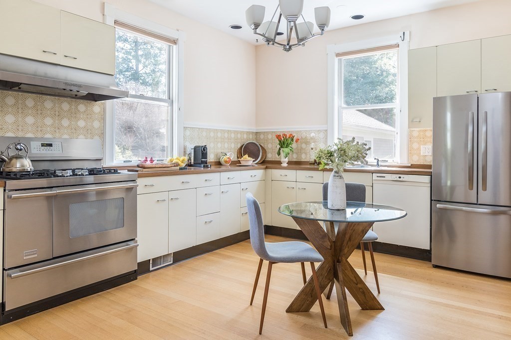 69 Garfield Street Watertown, MA 02472 - Photo 11 of 36 a kitchen with a stove a refrigerator and a sink