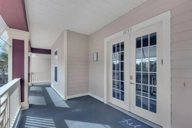 a view of a hallway with wooden floor and entryway