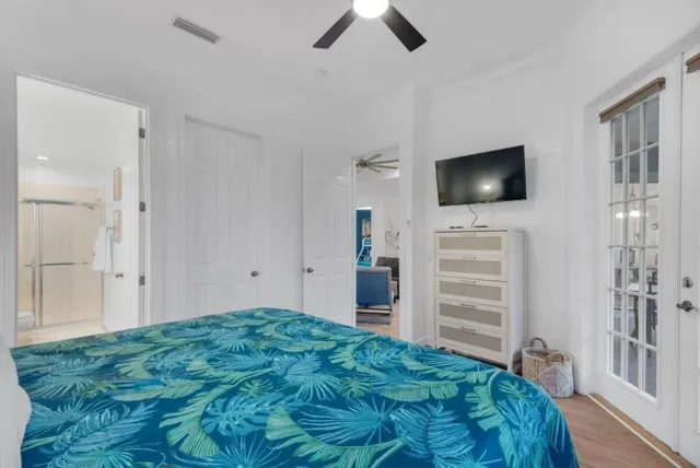 a bedroom with a bed and a flat screen tv