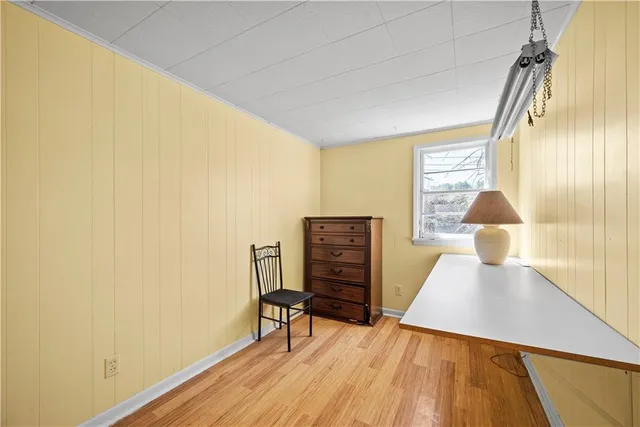 a view of a room with wooden floor and a window