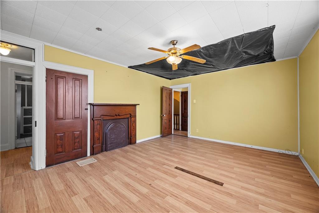 1276 Willowbrook Road Rostraver Township, PA 15012 - Photo 17 of 40 a bedroom with a bed and a chandelier