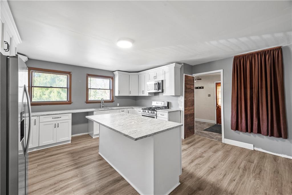 1276 Willowbrook Road Rostraver Township, PA 15012 - Photo 2 of 40 a kitchen with a sink stove and cabinets