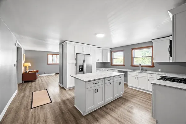 a kitchen with a stove a refrigerator and a sink