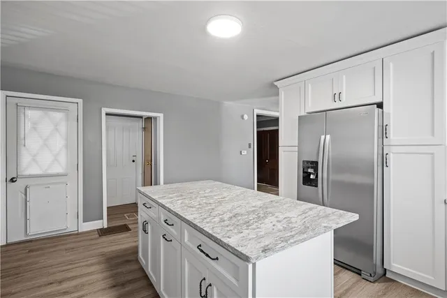 a kitchen with stainless steel appliances granite countertop a stove a sink dishwasher and a refrigerator