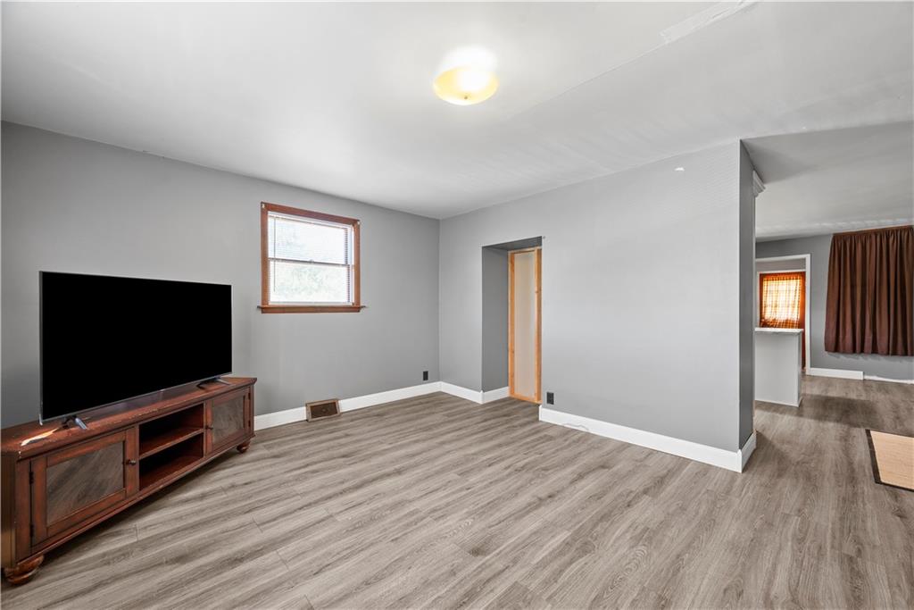 1276 Willowbrook Road Rostraver Township, PA 15012 - Photo 10 of 40 a view of a livingroom with wooden floor and a flat screen tv