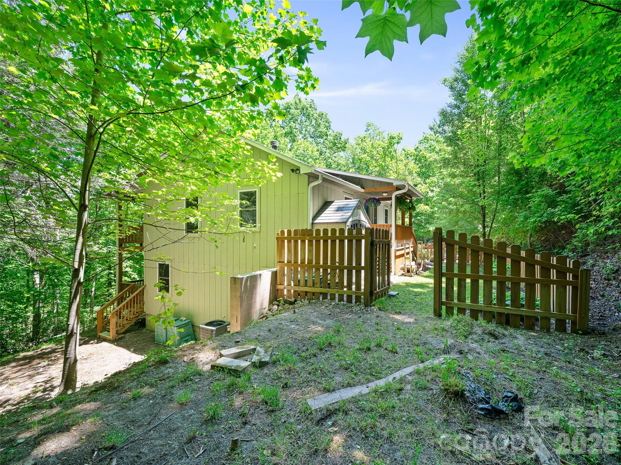 142 Wildflower Road Spruce Pine, NC 28777 - Photo 36 of 46 a view of a house with a yard and plants