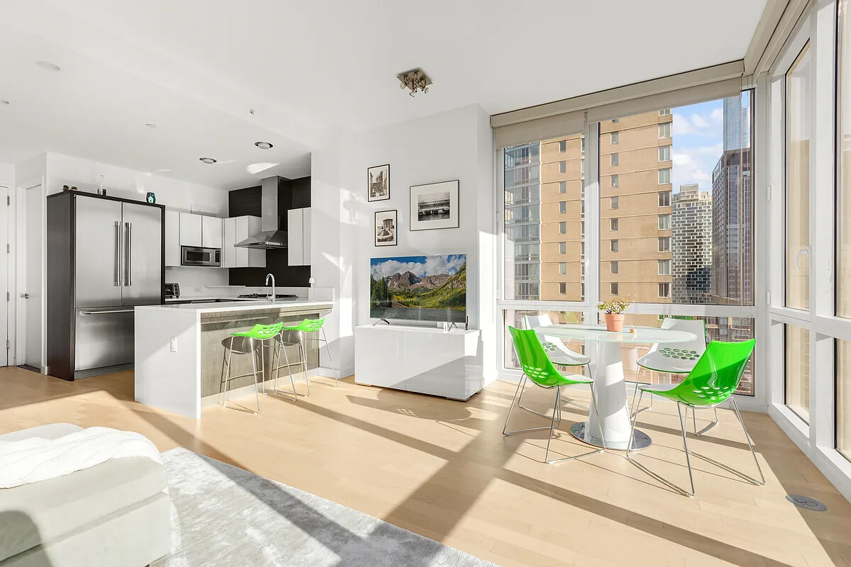247 West 46th Street, Unit 4104 Manhattan, NY 10036 - Photo 1 of 7 a large kitchen with kitchen island a large window in it